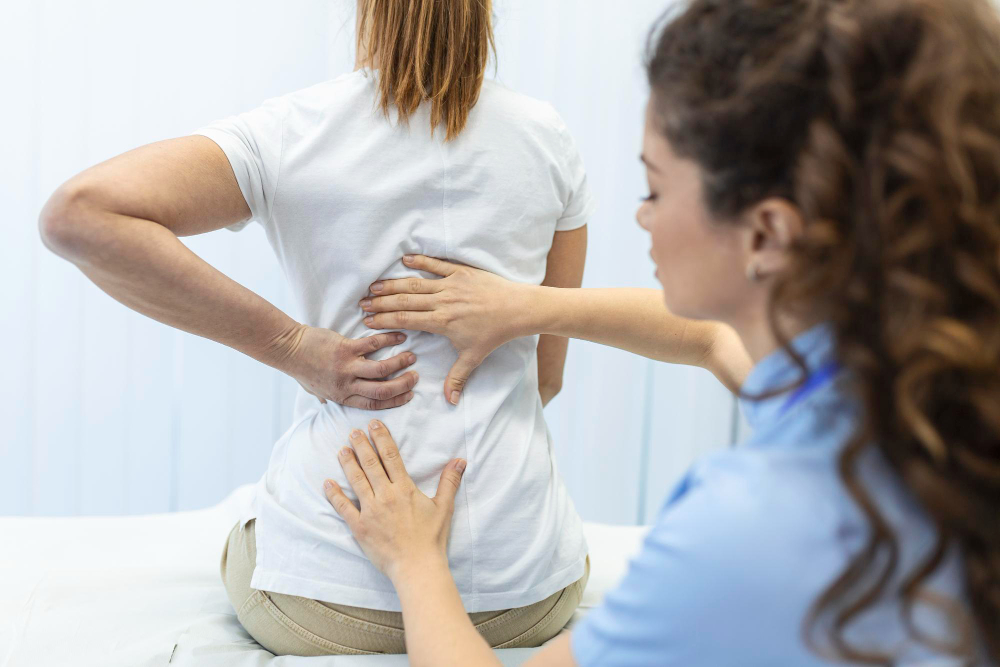 Physician assessing knee pain at Valoura Med Spa in Savoy, IL